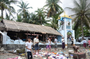 Local Arakanese dismantle and loot the site of a destroyed mosque in Sittwe, June 2012. © 2012 Private