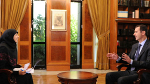Syria's President Bashar al-Assad (R) gestures during an interview with al-Manar TV in Damascus, in this handout photograph distributed by Syria's national news agency SANA, on May 30,2013 (Reuters)