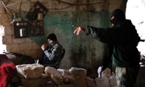 Fighters from Islamist Syrian rebel group Jabhat al-Nusra take their positions on the front line during a clash with Syrian forces loyal to President Bashar al Assad