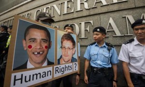Police officers stand guard outside the US consulate in Hong Kong during a demonstration of support for Edward Snowden, who is accused of leaking sensitive National Security Agency files. Photograph: Gareth Gay/Getty Images