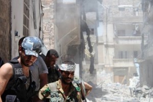 SALAH AL-ASHKAR / AFP / Getty Images Syrian rebels gather outside a building that they blew up to target a regime sniper taking shelter inside in the Salaheddine district of the northern city of Aleppo on July 10, 2013