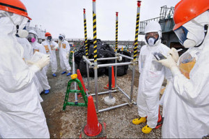 Reporters inspect an observation well which is dug to take underground water samples near Fukushima Dai-ichi nuclear plant Unit 1 of Tokyo Electric Power Co., in Okuma, Fukushima prefecture, northeastern Japan. Kyodo News/AP/File