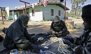 Aboriginal elders playing cards in their camp near Alice Springs. 'A typical, dilapidated house in an outback Indigenous community must accommodate as many as 25 people. Families, the elderly and disabled people wait years for sanitation that works.' Photograph: Anoek De Groot/AFP/Getty Images