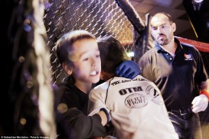 Parker, Arizona, United States: Kristofer "The Arm Collector" Arrey, 7, pins Cross Betzhold, 6, against the cage during a United States Fight League Pankration All-Star tournament held at the BlueWater Resort and Casino
