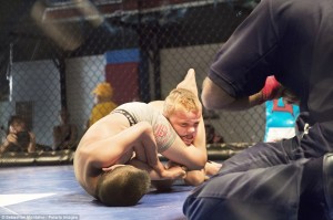 San Bernardino, California, United States: Mason "The Beast" Bramlette, 7, is choked by his opponent during a Pankration tournament held at Adrenaline Combat Sports and Fitness