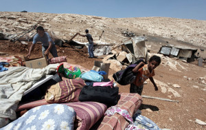 Palestinians removing their possessions after Israeli authorities demolished their homes [file photo]