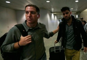 Glenn Greenwald walks with his partner David Miranda in Rio de Janeiro's International Airport. Reuters/Ricardo Morales/Landov