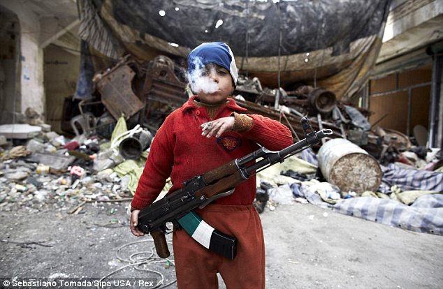 Children of war: The photo was taken in front of a barricade in the neighborhood of Salahadeen, Aleppo - the front lines of the bloody Syrian civil war