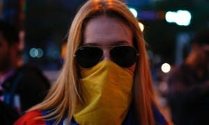 A Venezuelan protester poses for a portrait at Altamira square in Caracas. Photograph: Jorge Silva / Reuters