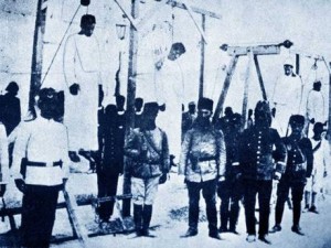 Ottoman soldiers posing in front of Armenians they have hanged.
