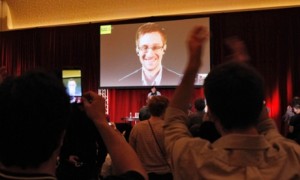 Supporters of Amnesty International cheer as Edward Snowden is introduced via video at a conference in Chicago on Saturday [5 Apr 2014]. Photograph: Frank Polich/Reuters