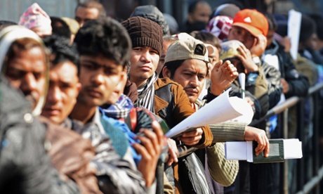 Nepalese migrant workers queue to receive official documents in order to leave Nepal from the labour department in Kathmandu. Photograph: Prakash Mathema/AFP/Getty Images