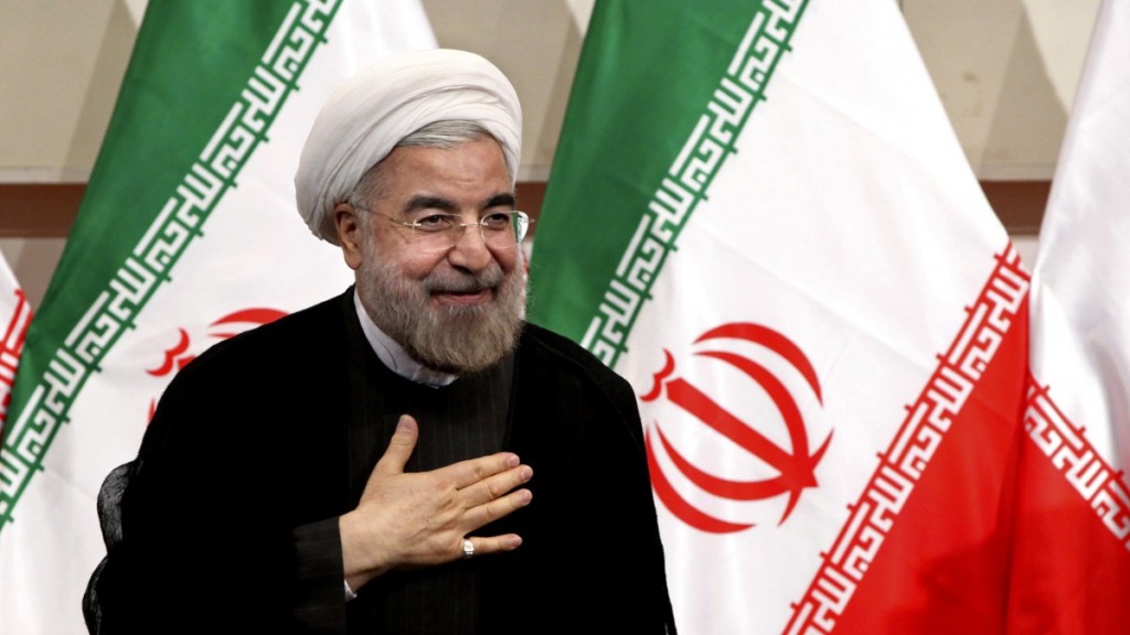 Presiden  Hasan Rouhani places his hand on his heart as a sign of respect after speaking at a news conference, in Tehran, Iran. Photo: Ebrahim Noroozi/AP