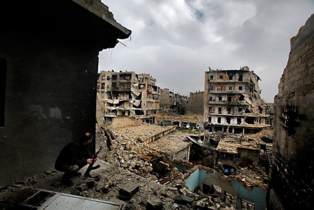 Abu Firuz, the commander of Liwa (Brigade) Salahadin, a Kurdish military unit fighting alongside rebel fighters, watches the besieged district of Karmel al-Jabl in eastern Aleppo, on Dec. 6, 2012. Several of the GCC states, specifically Saudi Arabia, UAE and Qatar, are significant suppliers of weapons, mostly unofficial and clandestine, to some of the warring factions in Syria, Libya, Iraq and Yemen. Credit: สังฆมณฑล เชียงใหม่/cc by 2.0