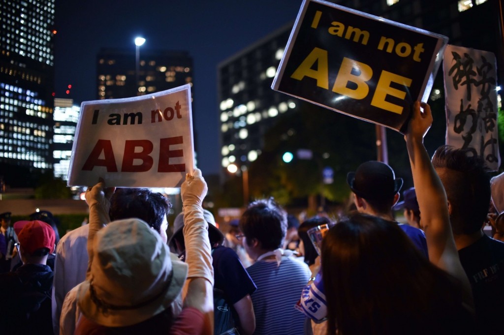 Protesters rally against the government of Japan's Prime Minister Shinzo Abe in Tokyo on Thursday after Japan's cabinet approved a set of bills bolstering the role and scope of the military. (Yoshikazu Tsuno/AFP/Getty Images)