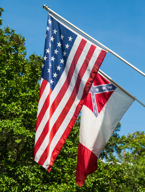 A Confederate flag flies behind the U.S. flag in Charleston, S.C., on Monday. (Darryl Brooks / Shutterstock.com)