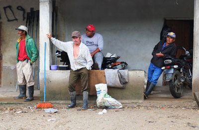 Men gather at a supply house in the peasant-run collective of La Confianza. The peasants have operated La Confianza since forcibly seizing it from the Dinant Corporation during the ongoing land conflict in Bajo Aguán. International Consortium of Investigative Journalists