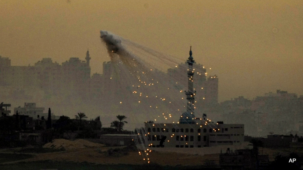 In this Friday Jan. 16, 2009 file photo, an explosion is seen from Israeli artillery during an Israeli military operation in the northern Gaza Strip, as seen from the Israeli side of the border. Israel fired white phosphorous shells indiscriminately over densely populated areas of Gaza in what amounts to a war crime, Human Rights Watch said in a report Wednesday. The Israeli military said Wednesday that the shells were used in line with international law.