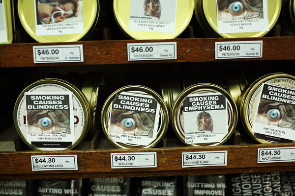 Plain packaged tobacco products with health warnings in Sydney, Australia. Credit Andrew Quilty for The New York Times