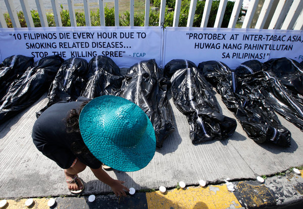 Protesters displayed fake body bags at a tobacco trade show at Pasay, the Philippines, in 2013. Credit Bullit Marquez/Associated Press