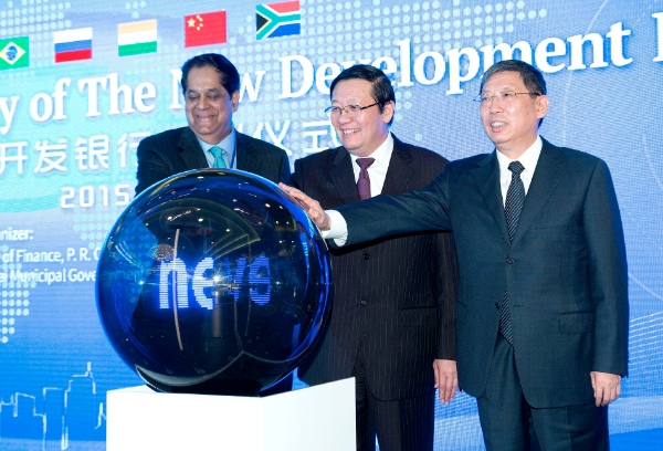 Chinese Finance Minister Lou Jiwei (C), Shanghai Mayor Yang Xiong (R) and President of the New Development Bank (NDB) of BRICS K.V. Kamath attend the launching ceremony of the bank in Shanghai, east China, July 21, 2015 [Xinhua]
