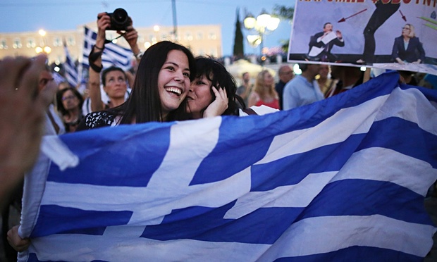 Greeks celebrate as early opinion polls predict a referendum win for the no campaign. Photograph: Christopher Furlong/Getty Images Europe