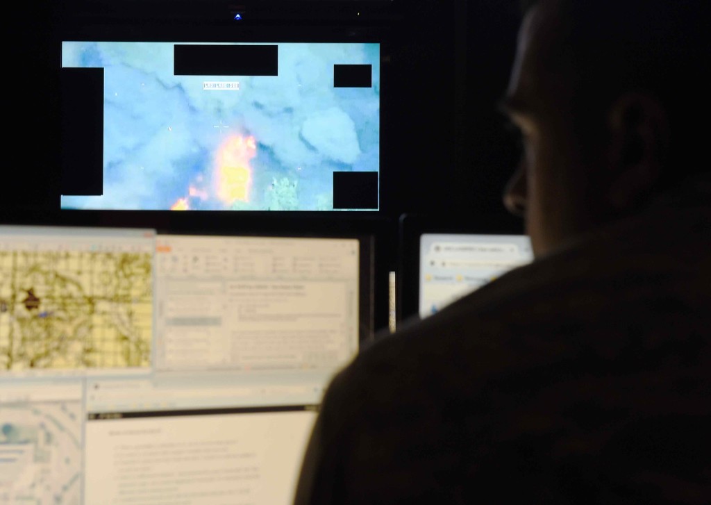 A U.S. Air Force analyst assigned to the 11th Intelligence Squadron reviews data prior to a full-motion exploitation mission on Hurlburt Field, Fla., June 11, 2015. The 11th IS executes procession, exploitation and dissemination of day and night imagery intelligence, from manned and unmanned aerial systems. (U.S. Air Force photo/Airman Kai White/Released)(Portions of this image were blurred for security or privacy concerns)