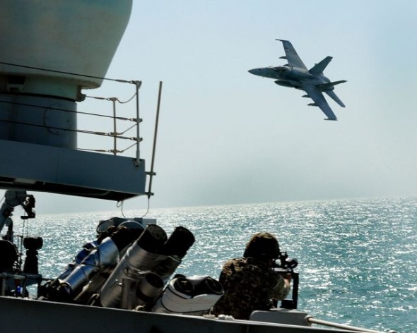 In an exercise, a Kuwaiti F18 Hornet fighter aircraft stages an attack on Royal Navy Type 23 frigate HMS St Albans. Currently, Israel and all six GCC countries are armed with state-of-the art fighter planes, mostly from the United States. Credit: Simmo Simpson/OGL license