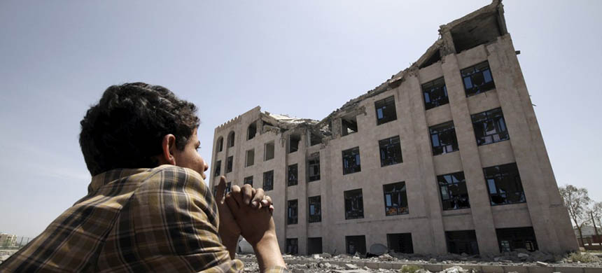 A Houthi militant sits amidst debris from the Yemeni Football Association building, which was damaged in a Saudi-led air strike, in Sanaa May 31, 2015. (photo: Mohamed al-Sayaghi/Reuters)