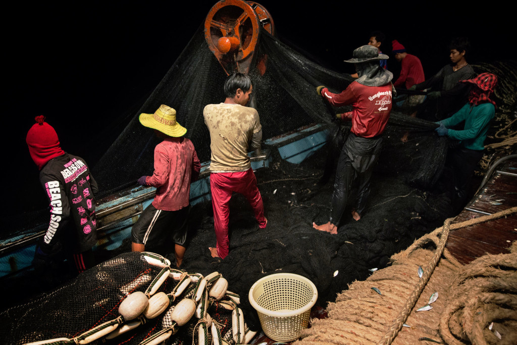 Cambodian migrants hauled in the nets on a fishing boat in the South China Sea. A labor shortage in the Thai fishing industry is primarily filled by using migrants, mostly from Cambodia and Myanmar. Credit Adam Dean for The New York Times