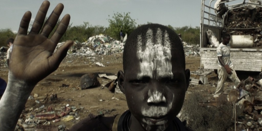 Adolescent boy from the Bari tribe, South Sudan, apparently imitating the tribal traditions of warriors putting ashes on their body. This ash is produced from burning trash. 