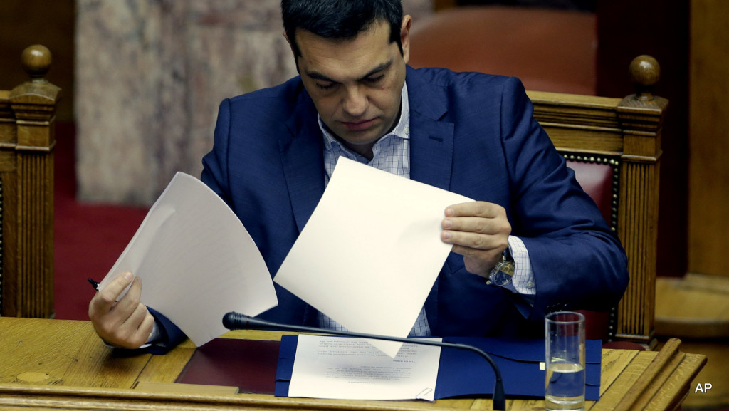 Greek Prime Minister Alexis Tsipras reads his notes as he prepares to answer opposition questions in parliament in Athens, on Friday, July 31, 2015. The third bailout will include a new punishing round of austerity measures heaped on a country reeling from a six-year recession and more than 25 percent unemployment. Tsipras has pledged to back the new cutbacks, while openly admitting that he disagrees with them.