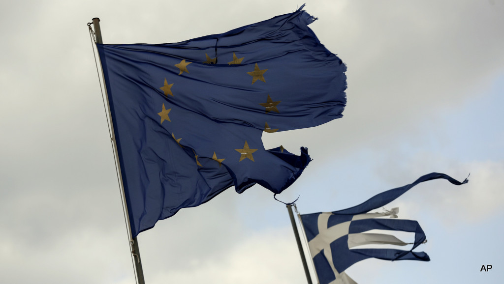 Ruined EU and Greek flags fly in tatters from a flag pole at a beach at Anavissos village, southwest of Athens, on Monday, March 16, 2015.