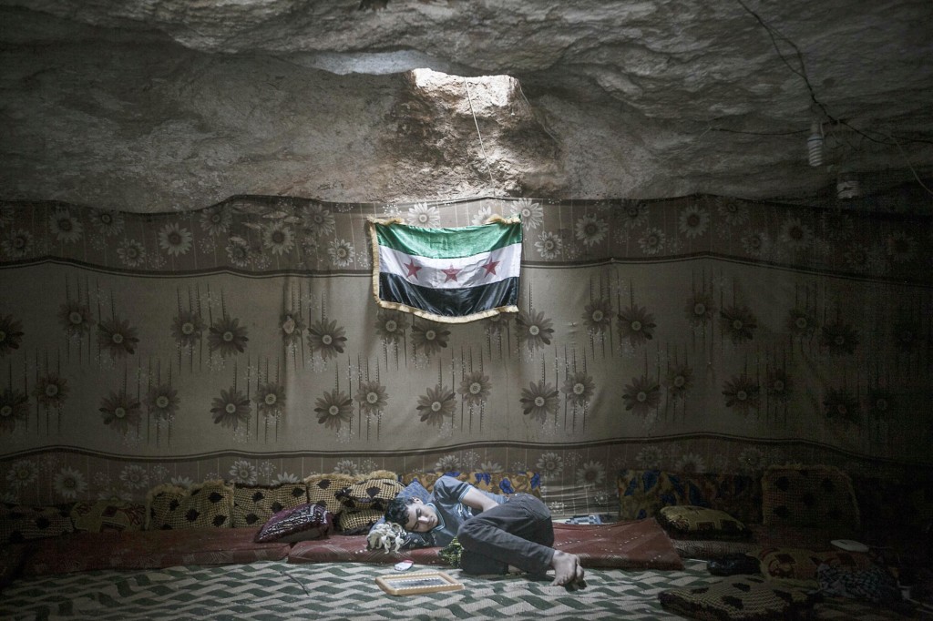  A Free Syrian Army fighter rests inside a cave at a rebel camp in Idlib, Syria on 17th September 2013. As of April 2015, moderate FSA rebels in Idlib have been supplanted by a US-backed rebel coalition led by Jabhut al-Nusra, al-Qaeda in Syria