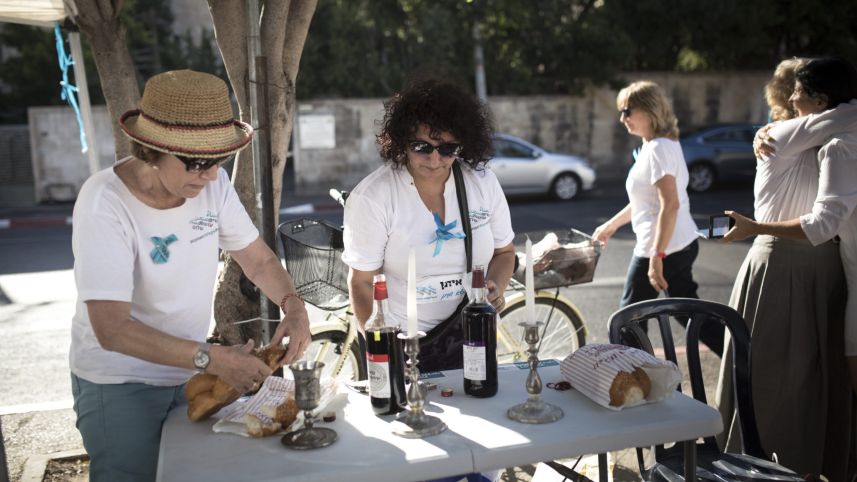  Women Wage Peace setting up for the Kabbalat Shabbat ceremony on July 10, 2015. Photo by Tali Mayer