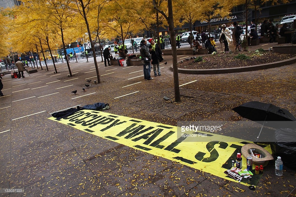 A sign sits on the ground in a nearly empty Zuccotti Park a day after it was cleared of Occupy Wall Street protesters in an early morning police raid on November 16, 2011 in New York city. Zuccotti Park became the epicenter of the global Occupy Wall Street movement. (Photo by Spencer Platt/Getty Images)
