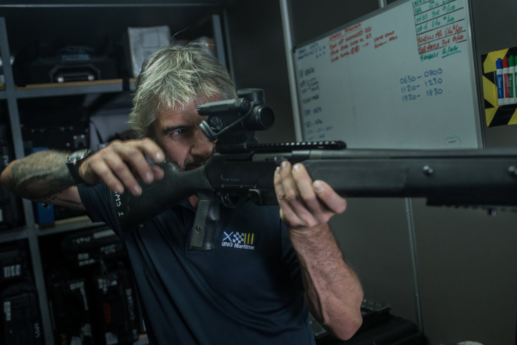 An employee inspected a rifle aboard the Resolution, a floating armory that anchored in the Gulf of Oman. CreditBen C. Solomon/The New York Times