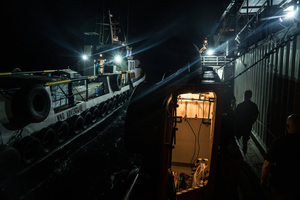 A smaller transport ship disconnected from the Resolution in the dead of night. CreditBen C. Solomon/The New York Times