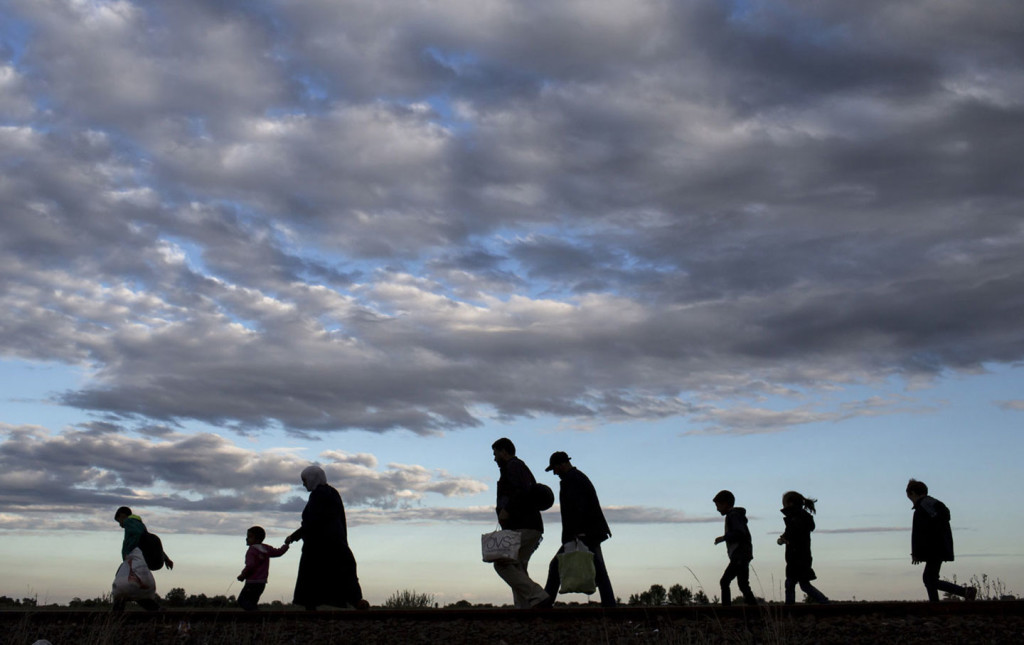 Migrants walk to a collection point in the village of Roszke, Hungary, September 6, 2015, after crossing the border from Serbia. (Marko Djurica / Reuters)