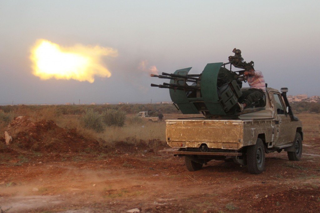  Rebel fighters fire a heavy machine gun during clashes with Syrian pro-government forces in the northwestern Idlib province, on August 31, 2015. (Omar Haj Kadour/AFP/Getty Images)