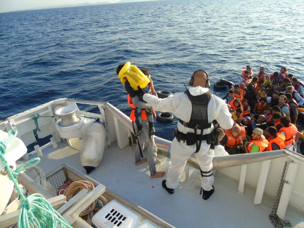 Rescued: Members of the National Criminal Investigation Service of Norway help people in the Mediterranean as part of Frontex's Operation Poseidon. Photo via