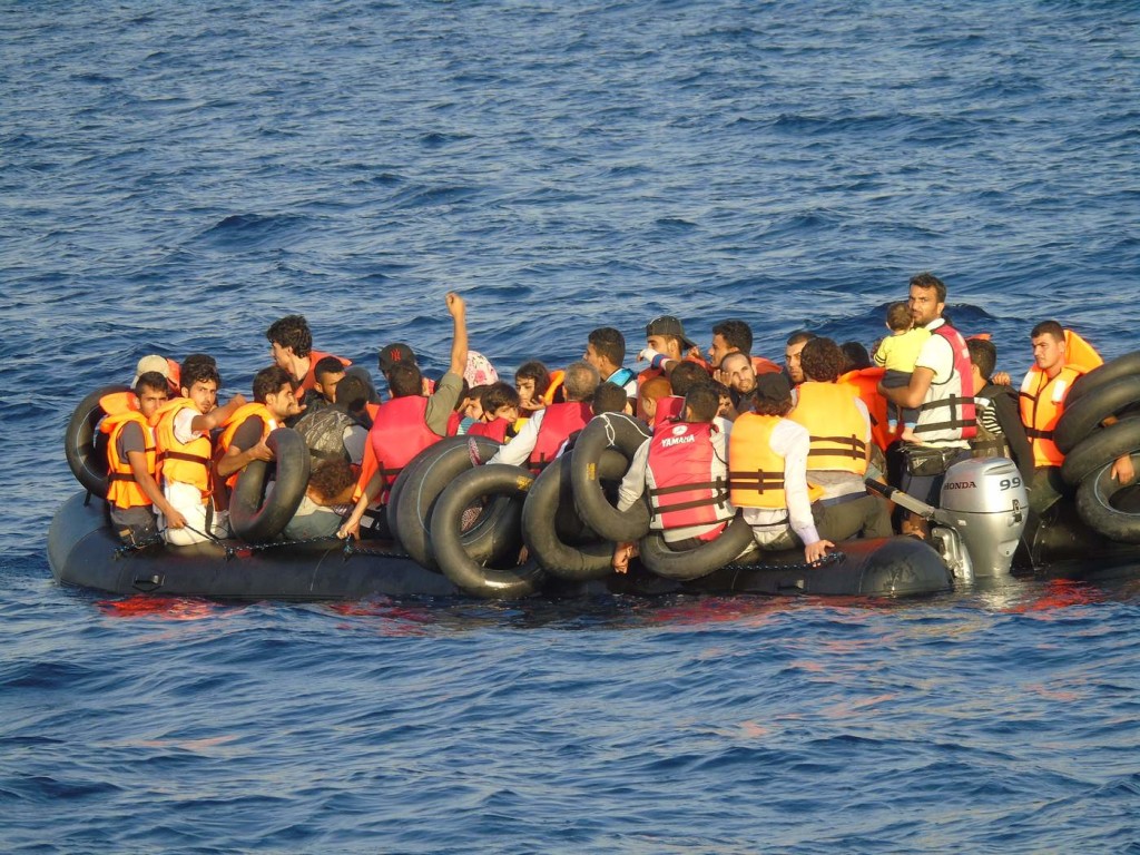 An overloaded dinghy in the Mediterranean, seen from a Norwegian ship participating in Frontex's Operation Poseidon