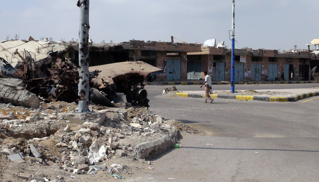 A man walks past destroyed buildings in Zinjibar, capital of Abyan province in southern Yemen on Dec. 5, 2012. Photo: Sami-al-Ansi/AFP/Getty Images