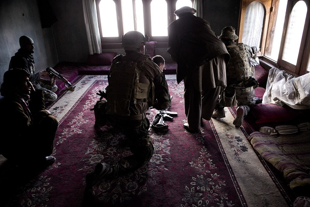 A village security force commander and coalition special operations forces identify insurgent fighting positions during a daylong firefight in Nuristan province, Afghanistan, April 12, 2012. Photo: U.S. Department of Defense