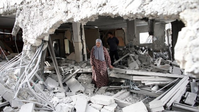 A Palestinian woman walks amid the rubble of a house after Israeli security forces demolished the homes of two Palestinians behind attacks in the Palestinian neighbourhood of Jabal Mukaber in East Jerusalem, on October 6, 2015. Photo by Thomas Coex / AFP