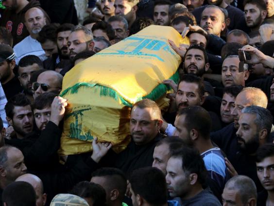Lebanese mourners carry the coffin of Adel Tormos, who had tried to stop the bomber from entering the Shiites mosque full of worshipers but was killed in the attempt