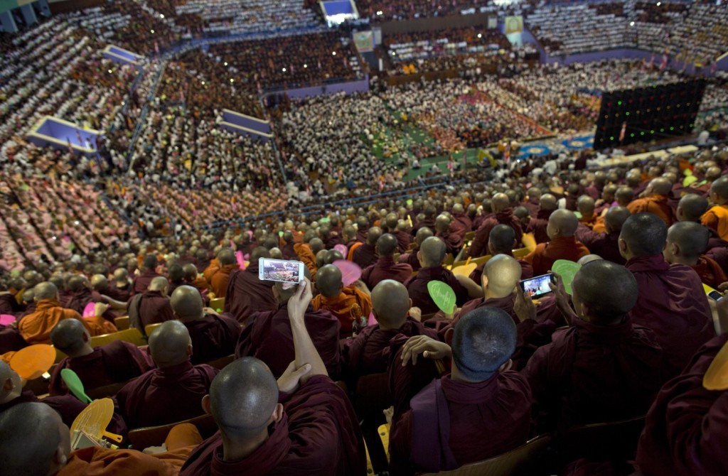  Buddhist monks take pictures with their phones during a gathering of nationalist monks and their supporters to celebrate four controversial bills, which recently became laws, in Rangoon on Oct. 4. (Gemunu Amarasinghe/AP)