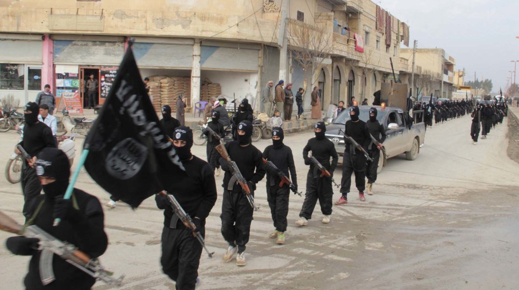 ISIS militants parade in Tel Abyad, Syria, on the border with Turkey in 2014. Reuters