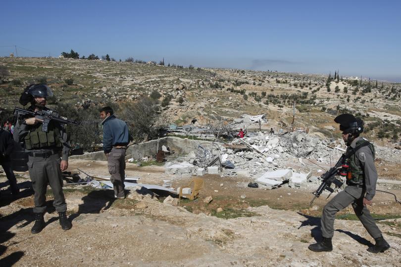  January 2015, police guard the spot where Palestinian homes have been demolished – a week after the government announced tenders for 430 new settlement homes for Jews. Photo by Mussa Qawasma.