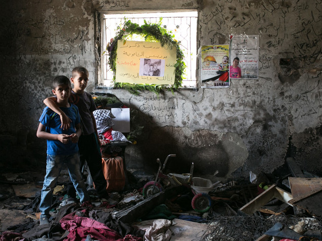 7 septembre 2015 - Des enfants se tiennent dans la maison incendiée de la famille Dawabsheh avant les funérailles de la maman Riham, qui a succombé à ses blessures un mois après que l’incendie criminel provoqué par des extrémistes juifs ait tué son bébé Ali et son mari Saad - Photo : ActiveStills/Yotam Ronen